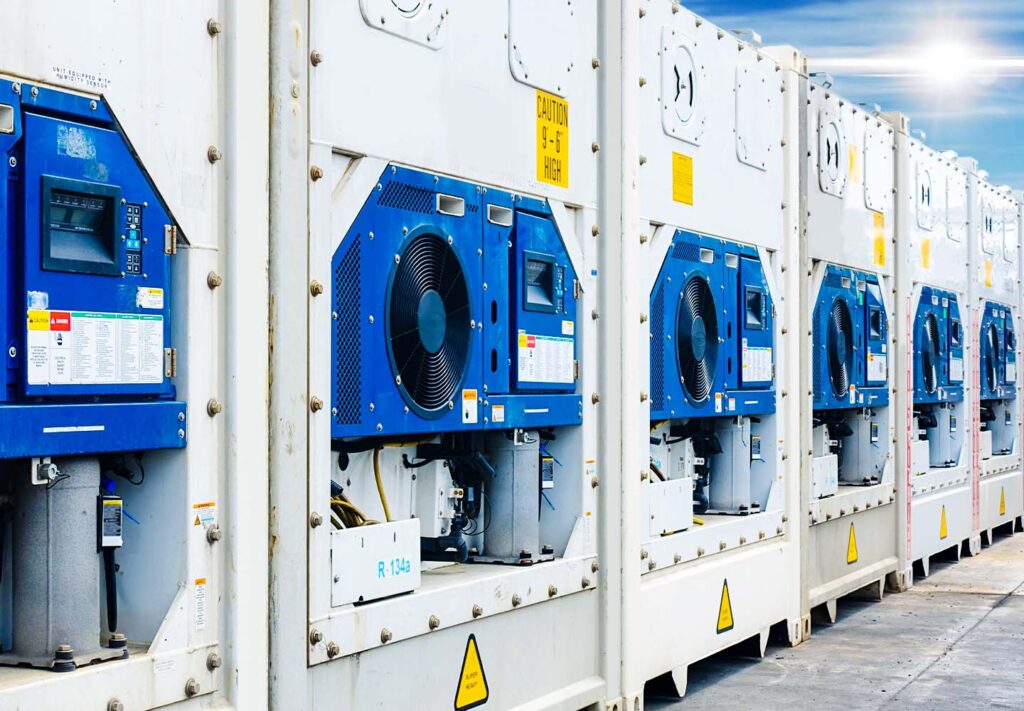 Row of refrigerated shipping containers with gensets