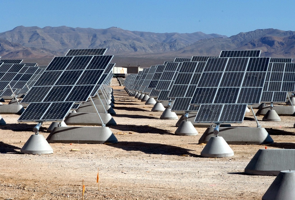  A massive solar farm with rows of tilted solar panels in a photovoltaic power station