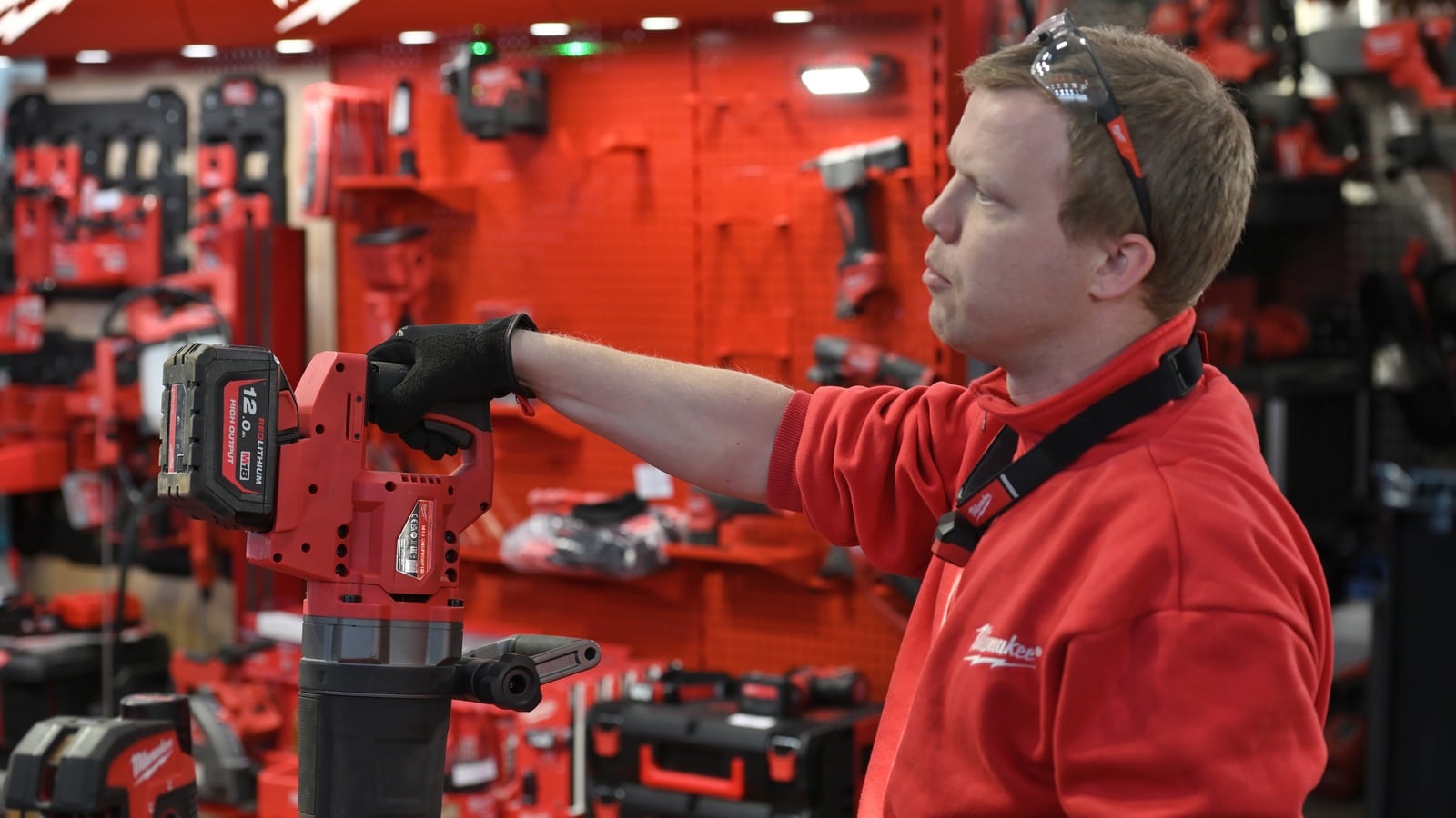 Employee inspecting Milwaukee fuel powered tools in a hardware store