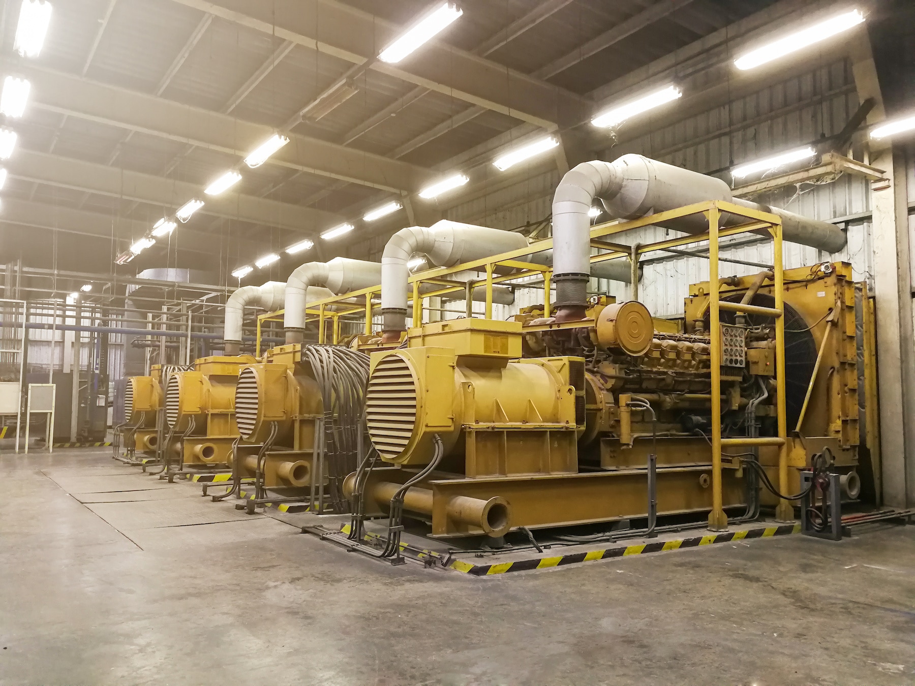 Industrial Power Solutions: A row of large diesel generators providing backup power to a facility