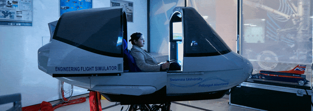 A woman in a electromechanical engineering flight simulator